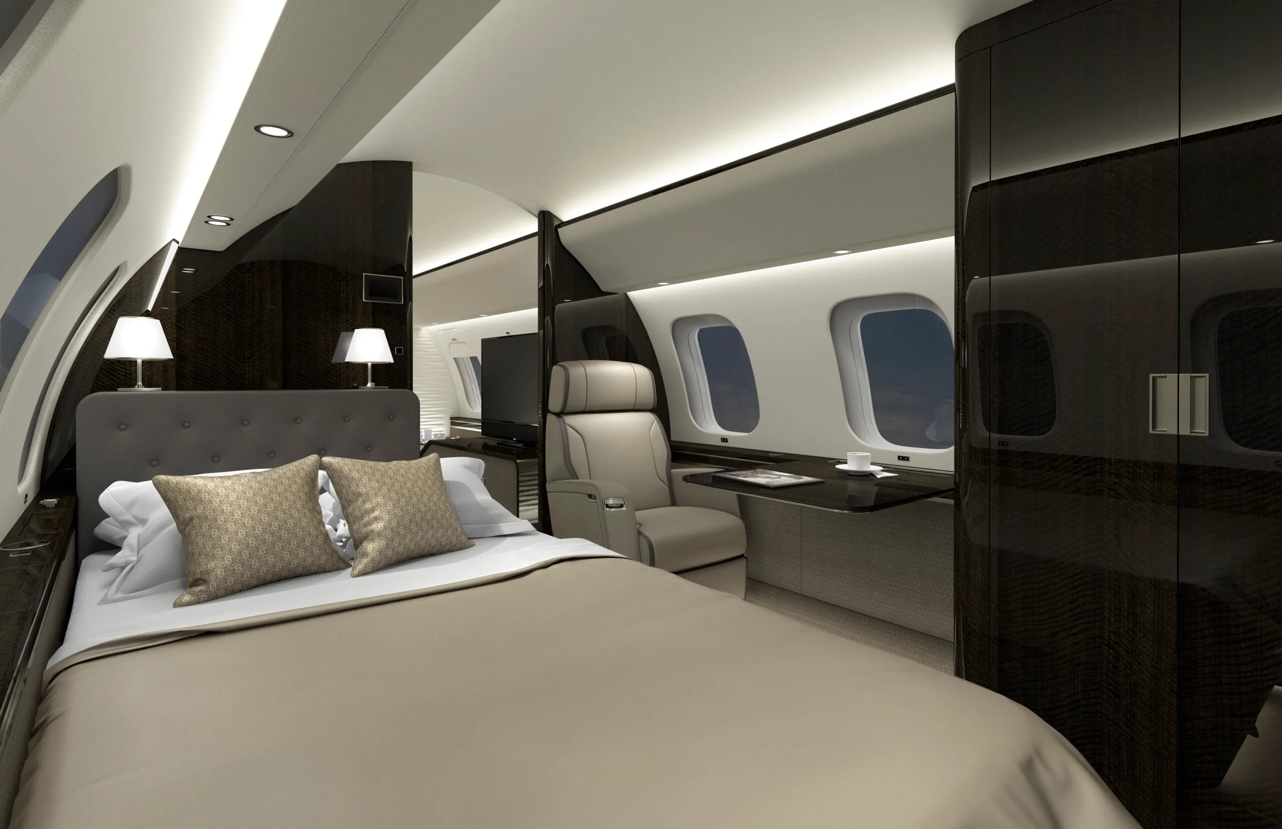 Luxurious aircraft interior with a bed and seating area.