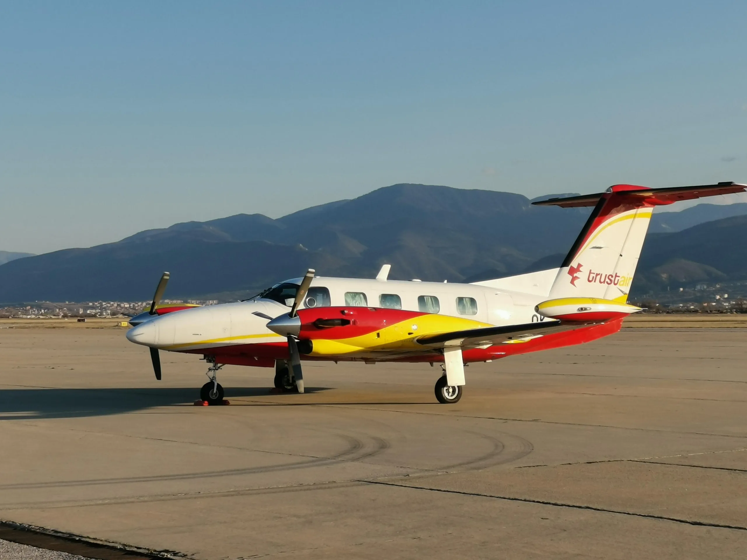 Side view of the Cheyenne III aircraft with mountains in the background.
