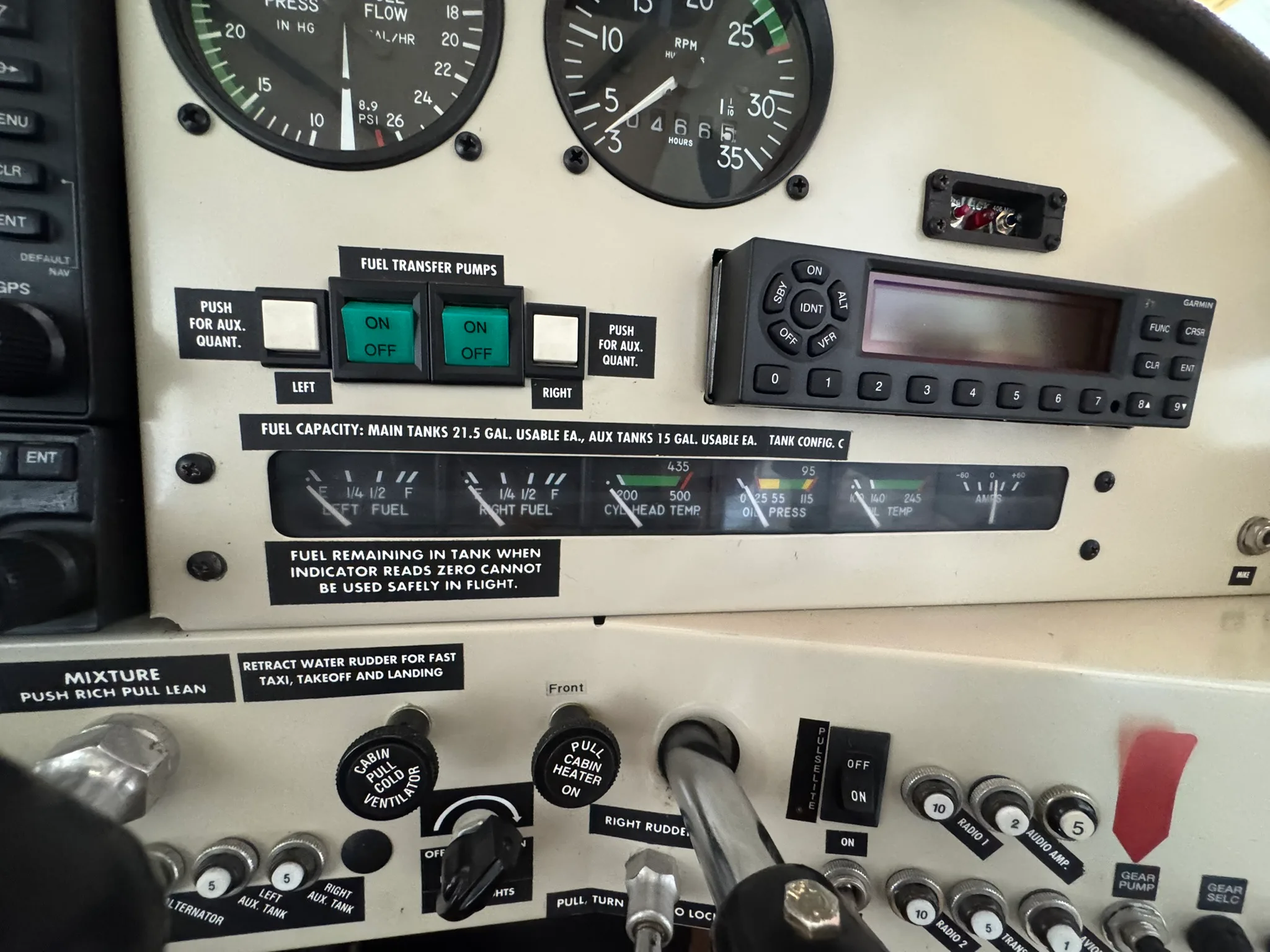 A close-up of the aircraft's instrument panel showing fuel transfer pumps, fuel gauges, and radio.