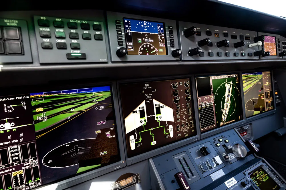 A wide view of the spacious and modern cockpit with two pilot seats and a full array of controls.