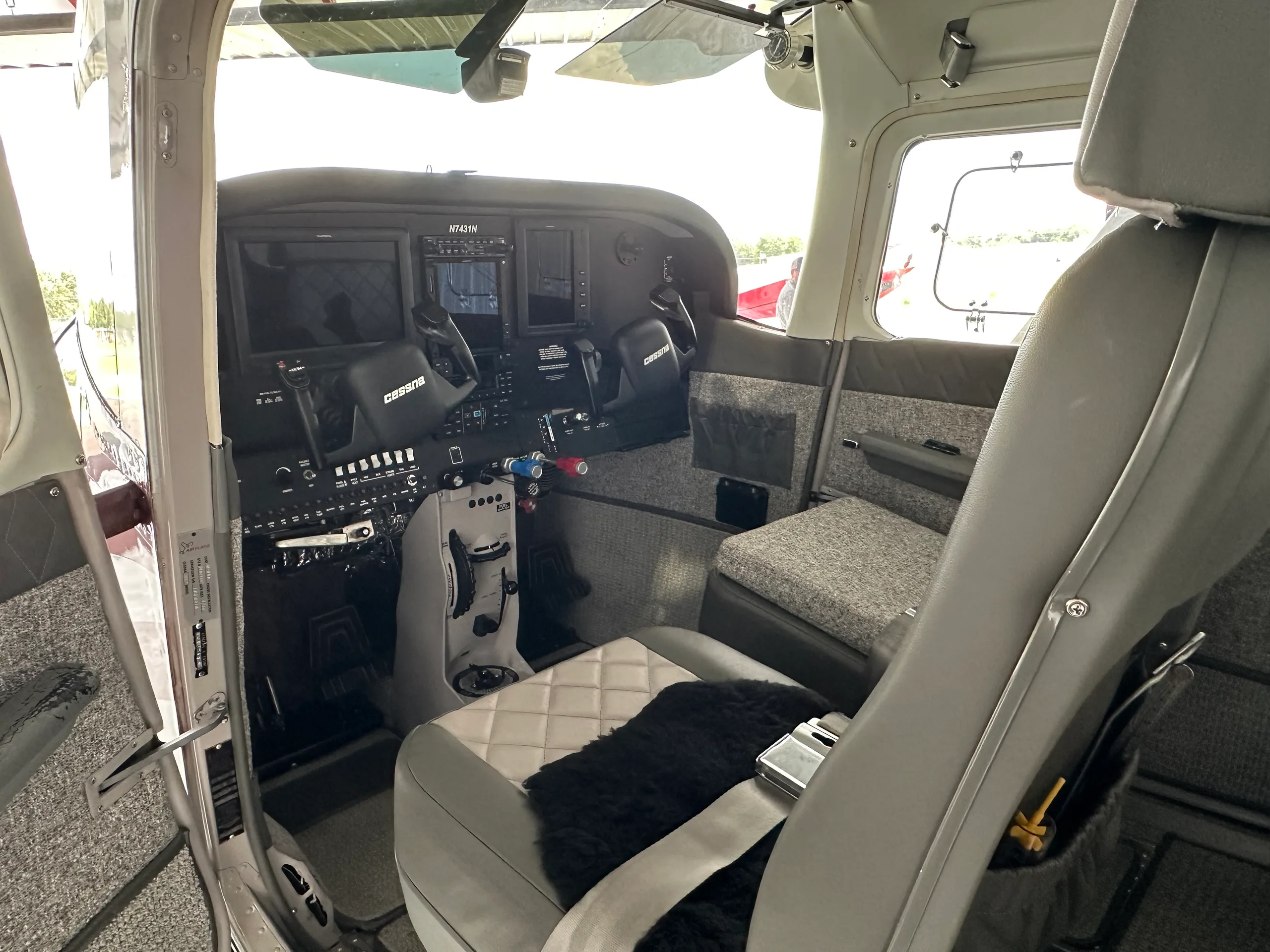 View of the Cessna 182 Skylane cockpit from the open door.