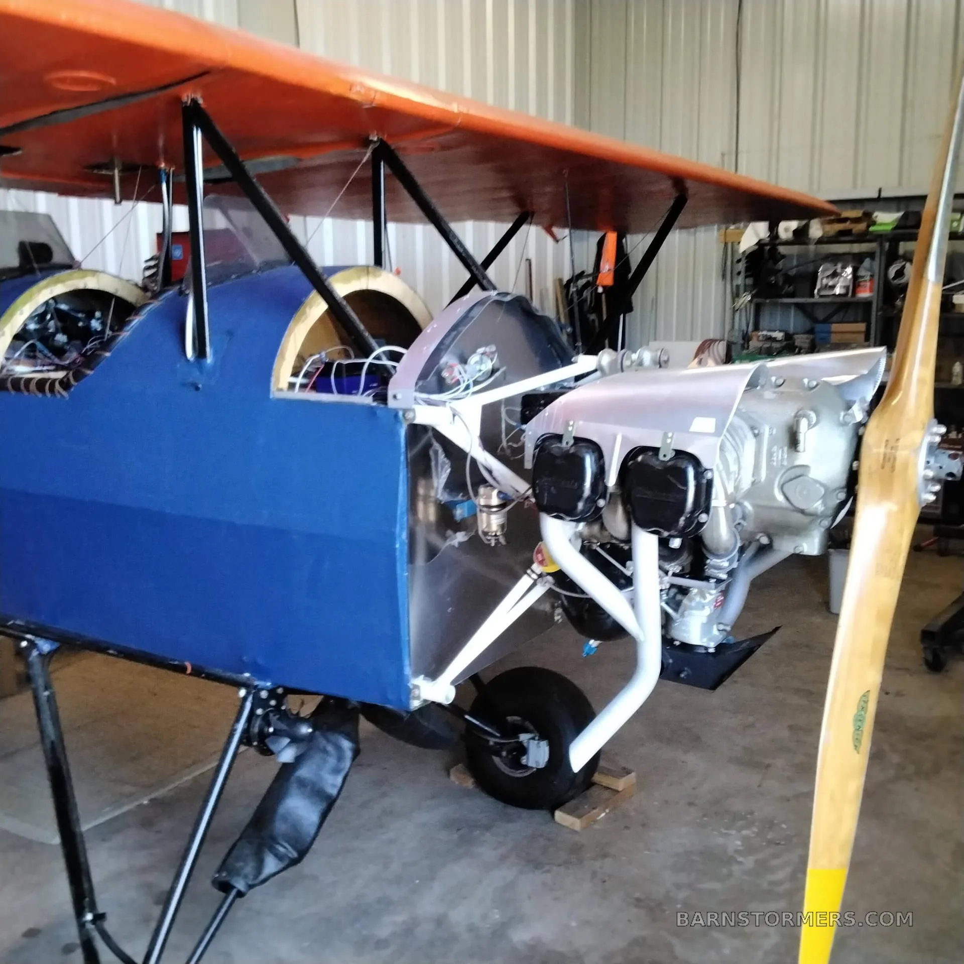 A close-up view of a vintage-style aircraft cockpit with a leather-wrapped control yoke and analog gauges.