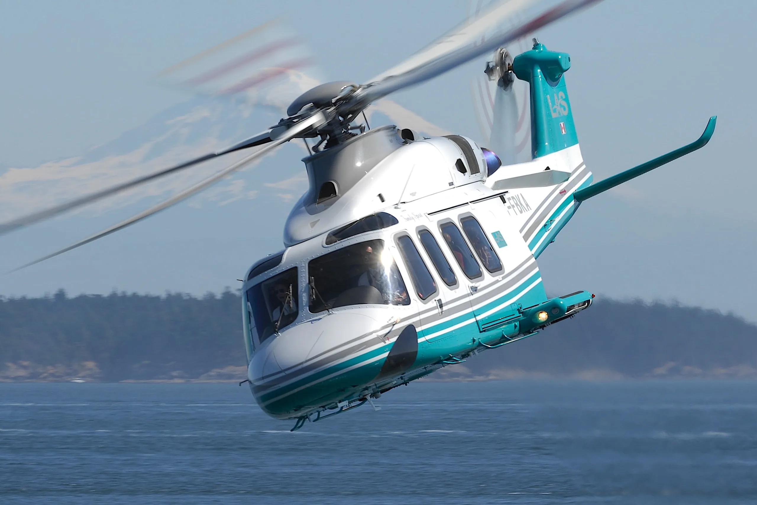 AgustaWestland AW139 helicopter in flight over water.