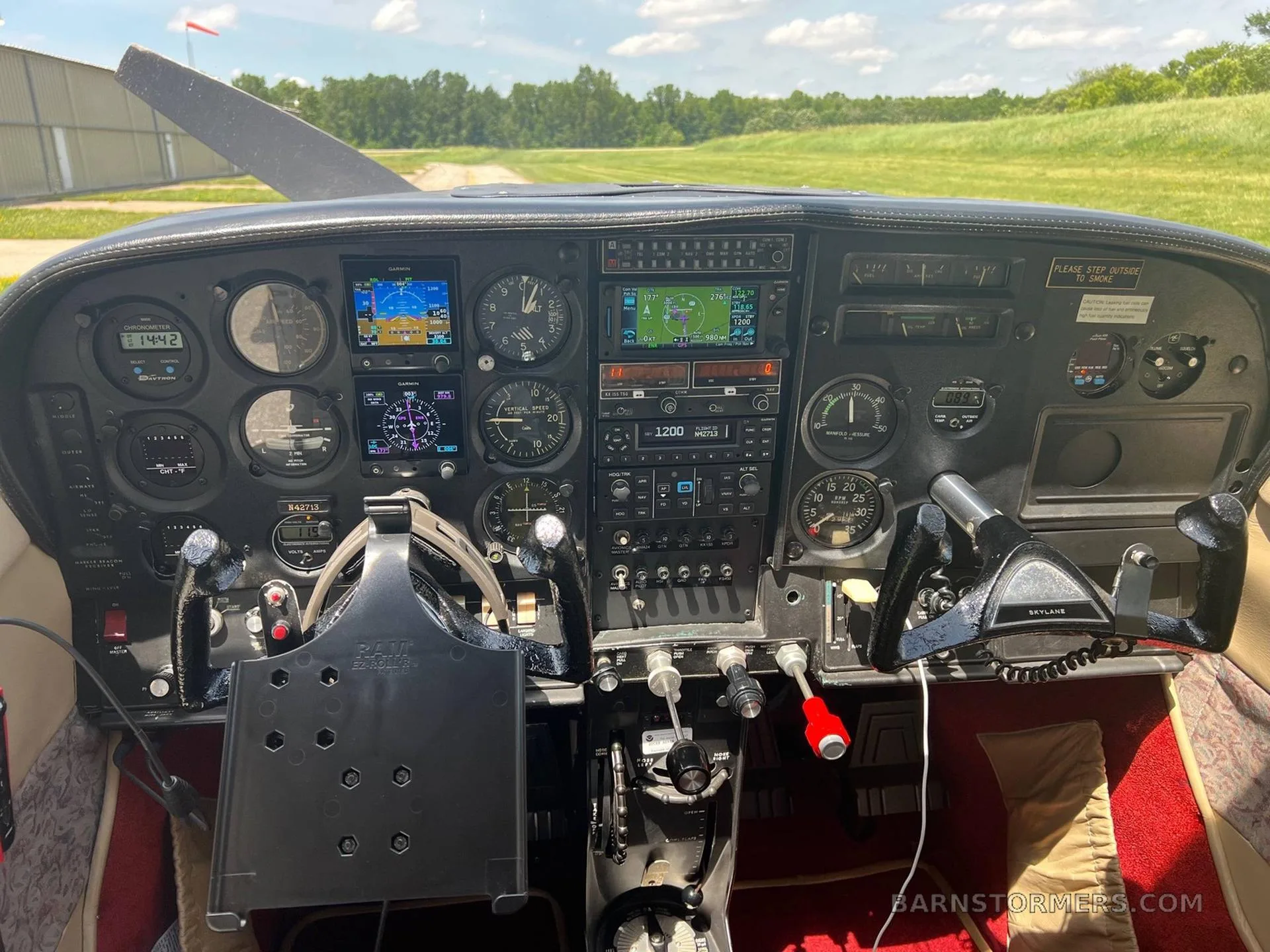 The cockpit of a Cessna aircraft showing the instrument panel with analog gauges and digital displays.