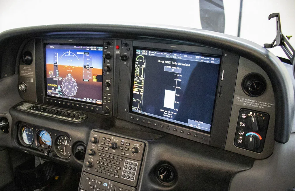 The cockpit instrument panel of a Cirrus SR22 Turbo, featuring two large digital displays and various controls.