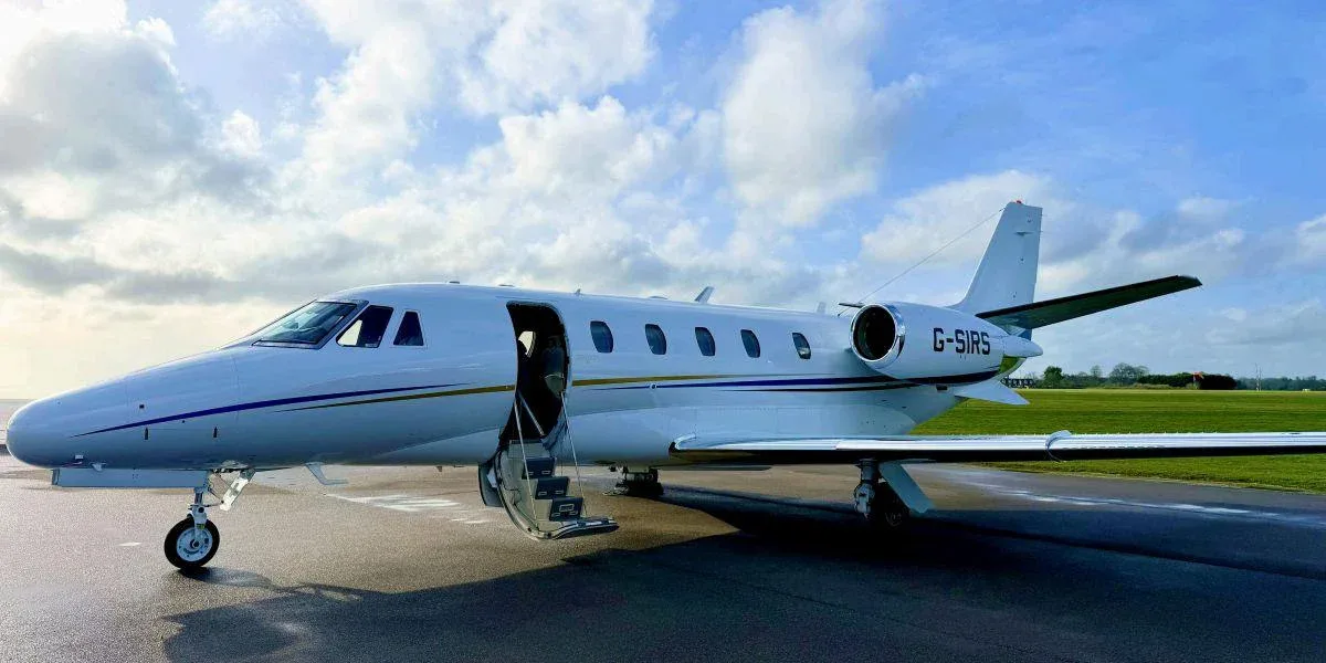 A Cessna Citation business jet parked on the tarmac with the door open.