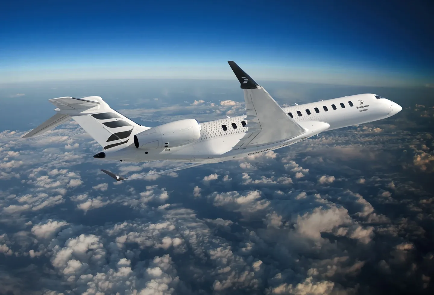 A white Bombardier Global 8000 business jet with black tail accents flies above a layer of clouds.