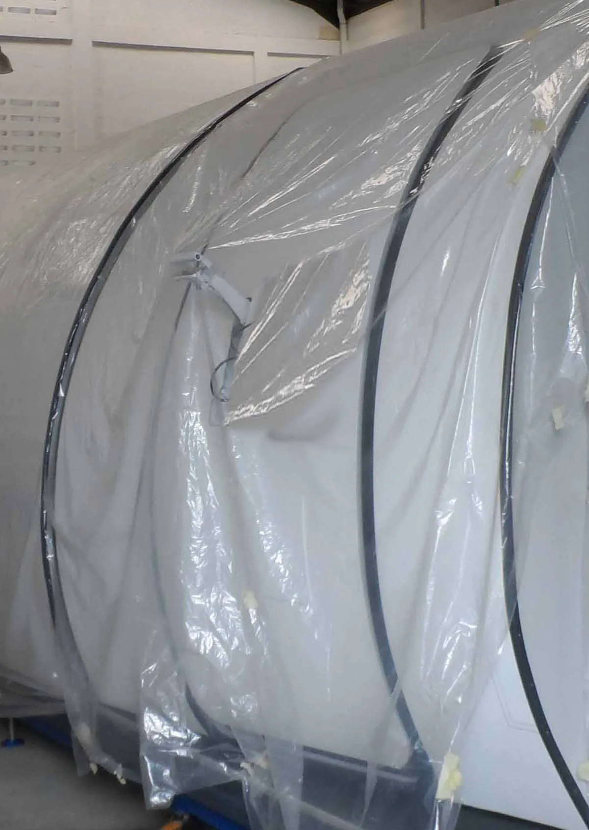 An aircraft cabin door with a wrapped blue seat to the left, showing the "ARMED" indicator.