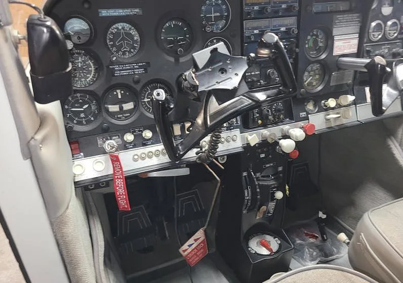 A detailed view of the aircraft's instrument panel, yokes, and center console.