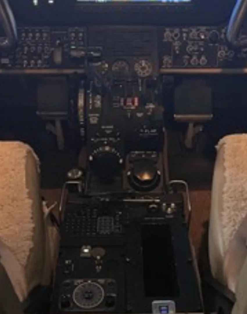 A close-up view of the aircraft's center console and lower instrument panel, showing various controls and switches.