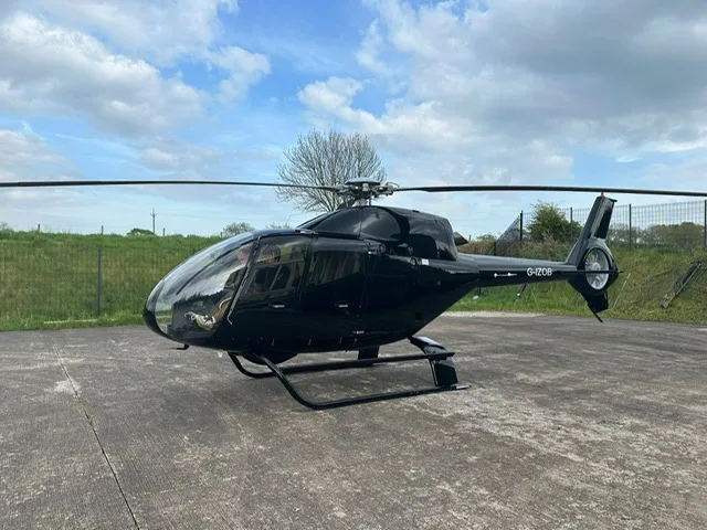 G-IZOB helicopter on the ground with a black paint scheme.