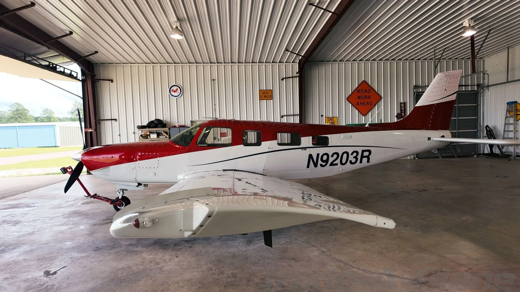 A side view of the aircraft in a hangar.
