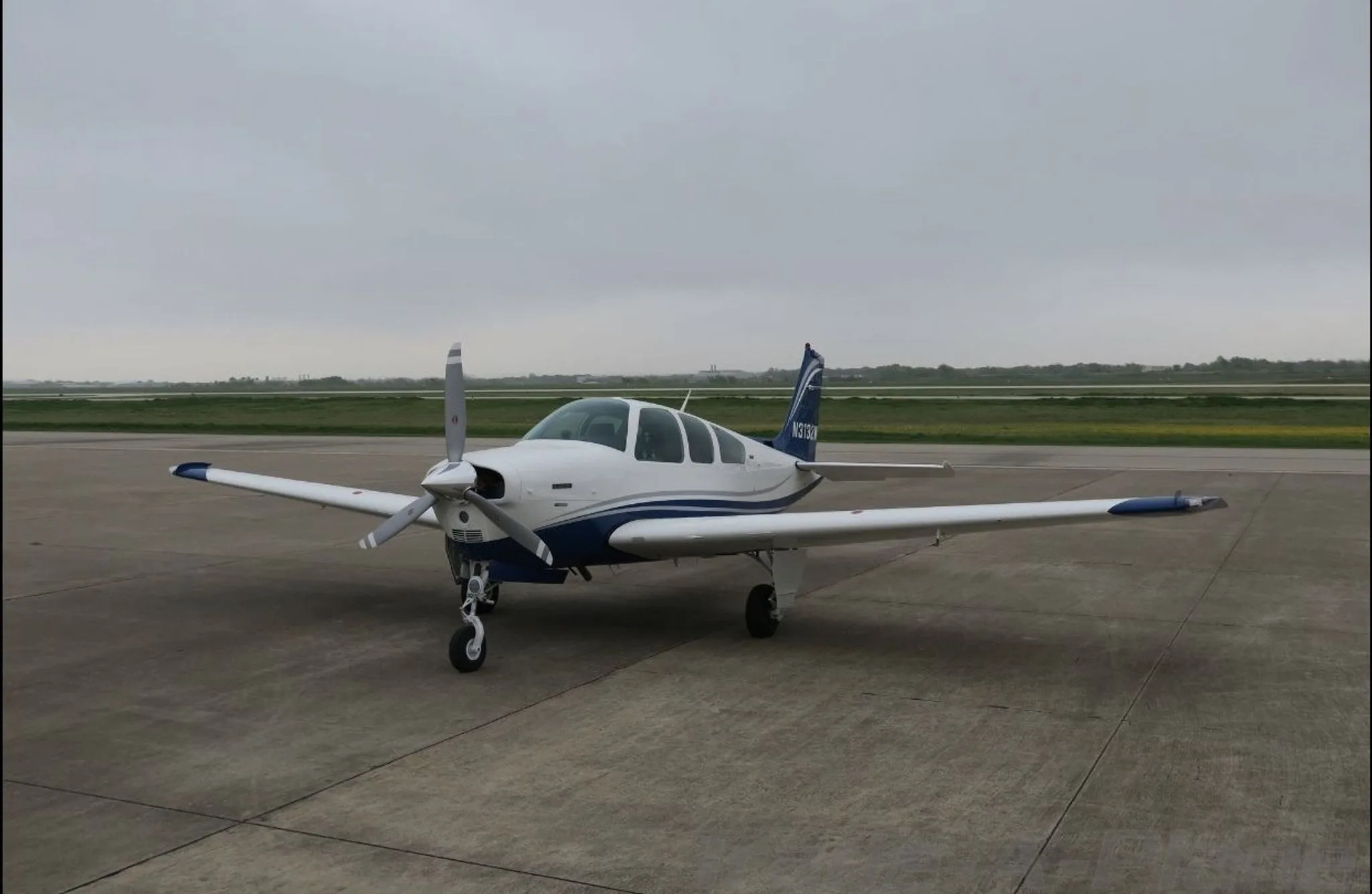 A Beechcraft 33 Bonanza parked on the tarmac.