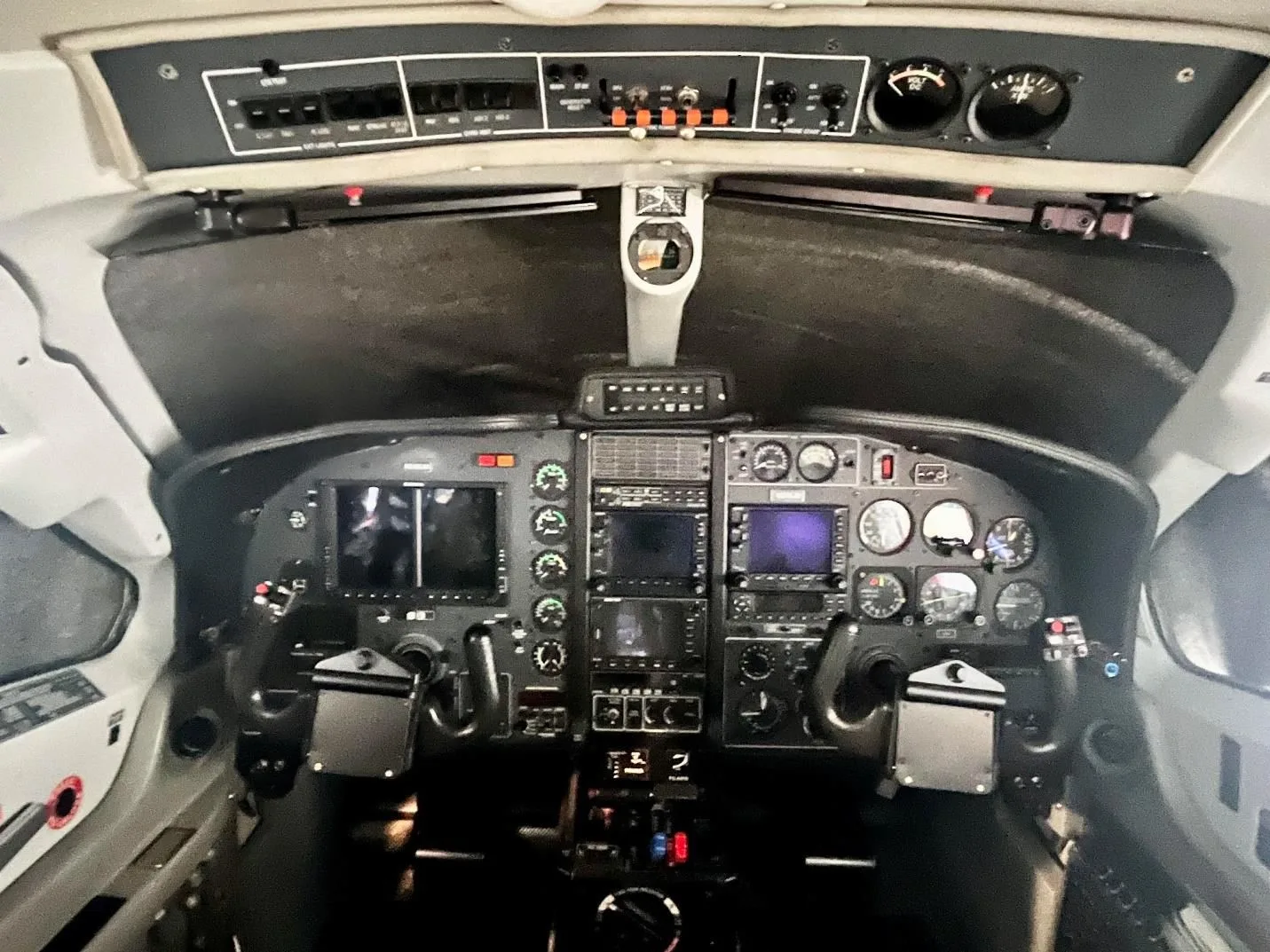 The detailed instrument panel and controls of the aircraft cockpit.