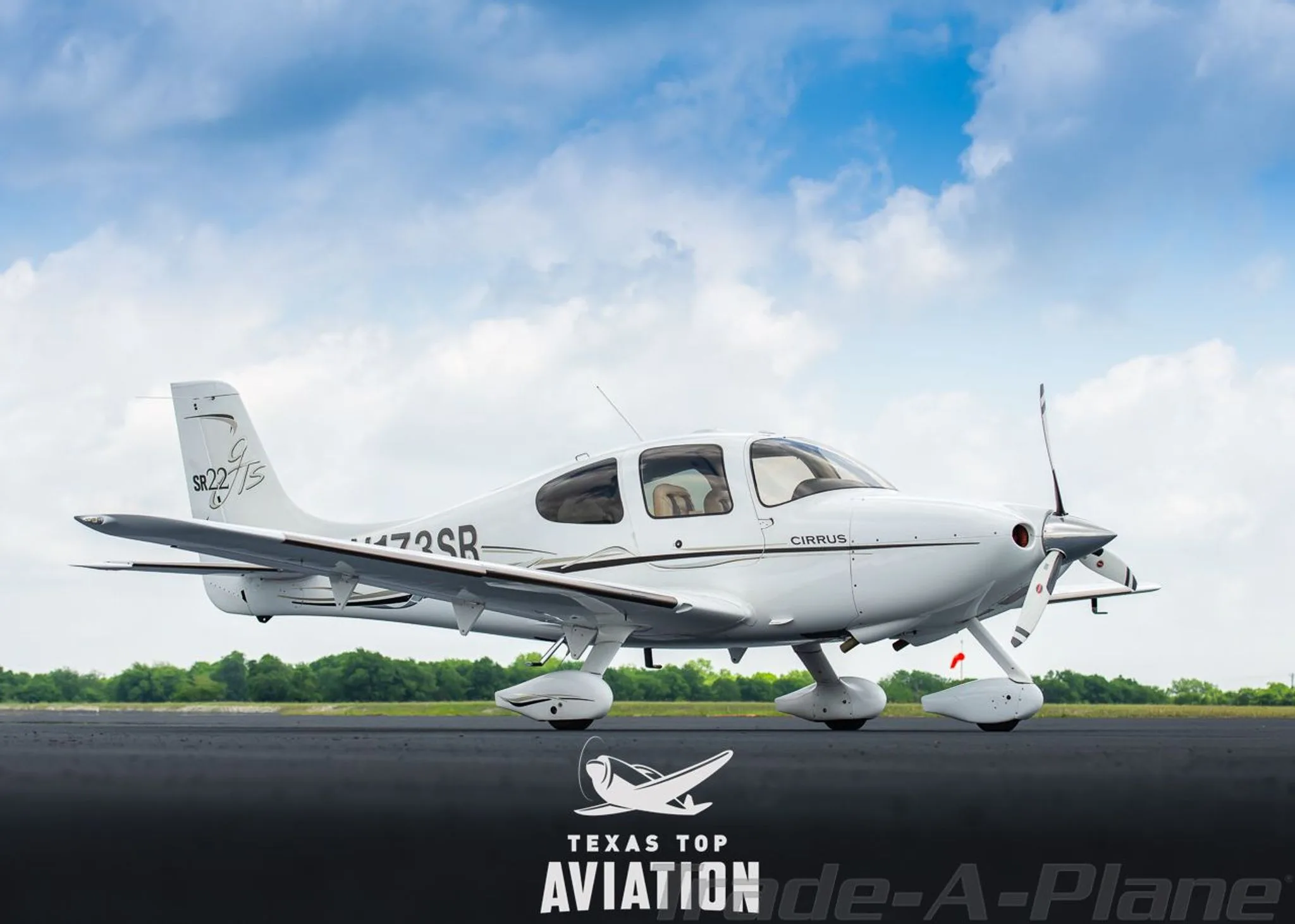 A side view of a white Cirrus SR22 aircraft, registration N173SR, parked on an airfield with its doors closed.