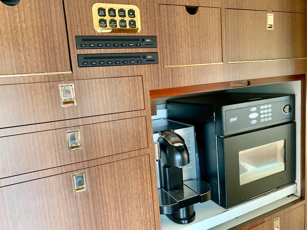 A view of the aircraft's interior with a coffee maker and microwave.