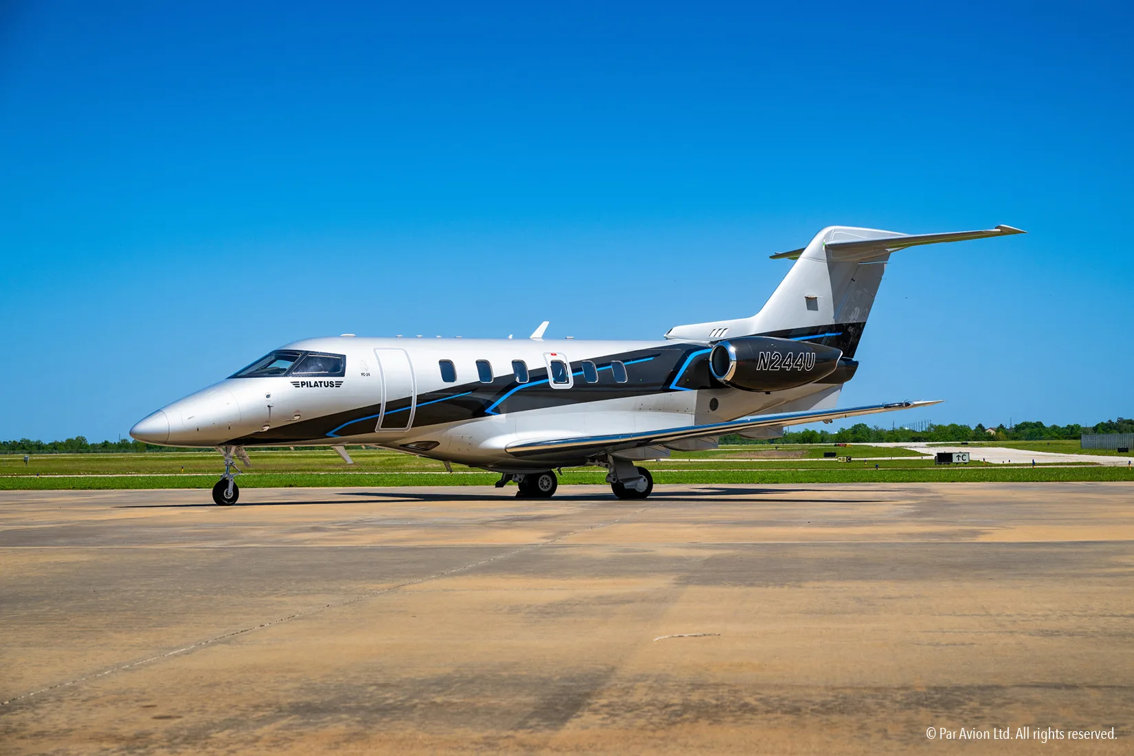 Pilatus PC-24 on the tarmac with a silver and black paint scheme.
