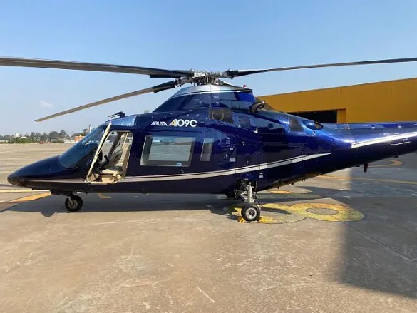 A side view of the AGUSTA AW-109 A109C on the ground.