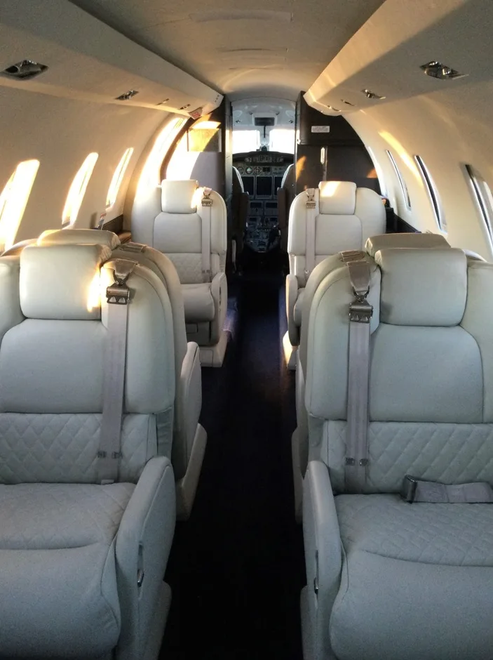 View of the aircraft's interior with white leather seats.