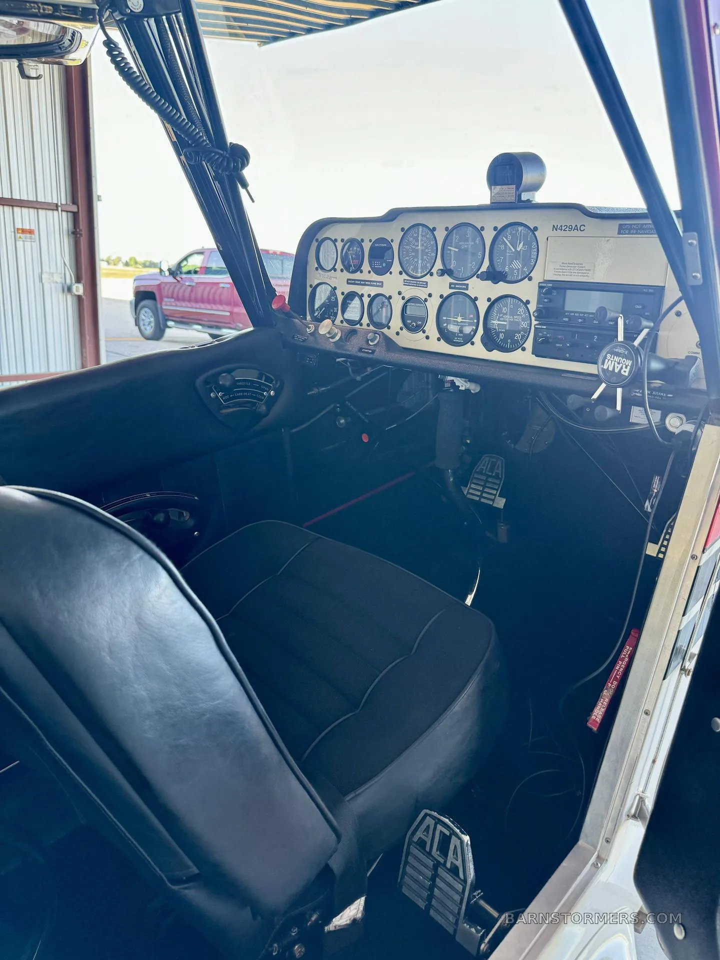 The cockpit of the N429AC aircraft, showing the instrument panel, controls, and pilot's seat.