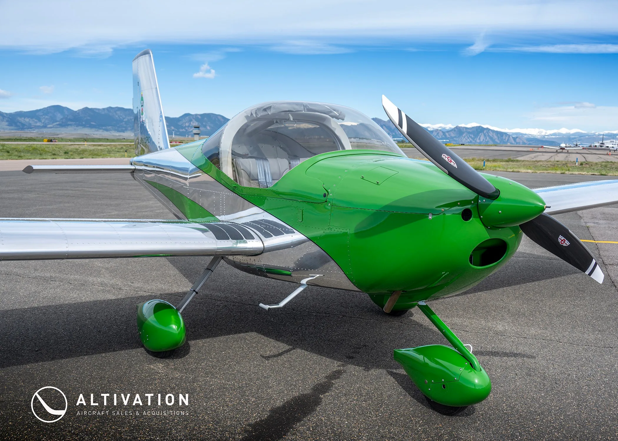 A front-quarter view of a green and polished aluminum Vans RV-12 aircraft, registration N612PC, highlighting the cockpit canopy and propeller.