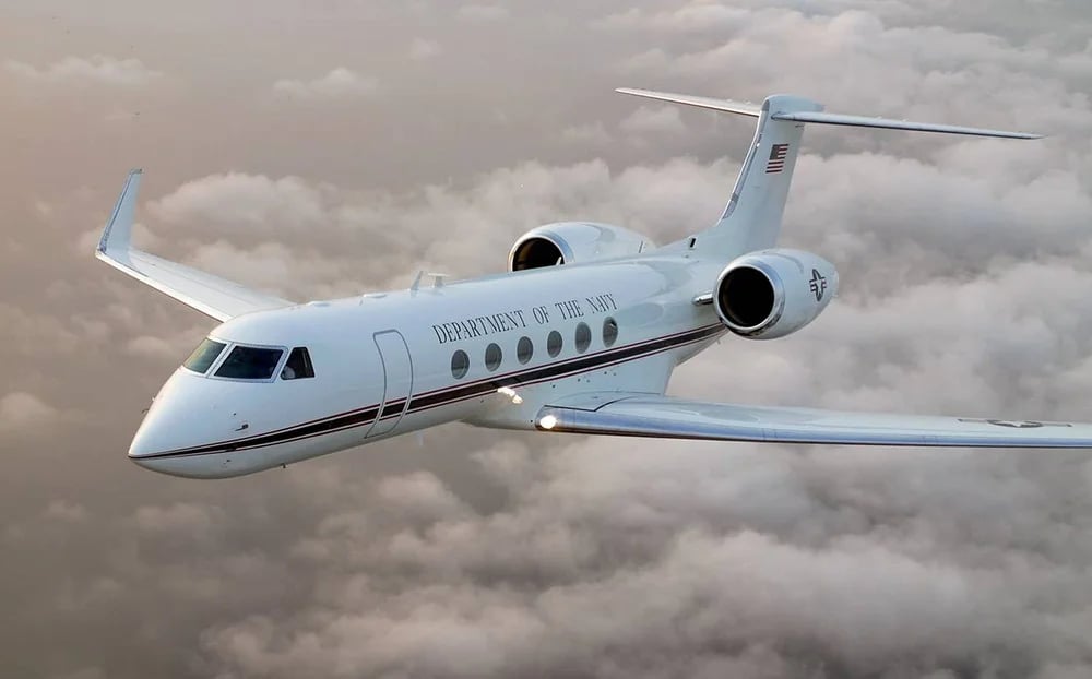A Department of the Navy Gulfstream in flight over clouds.