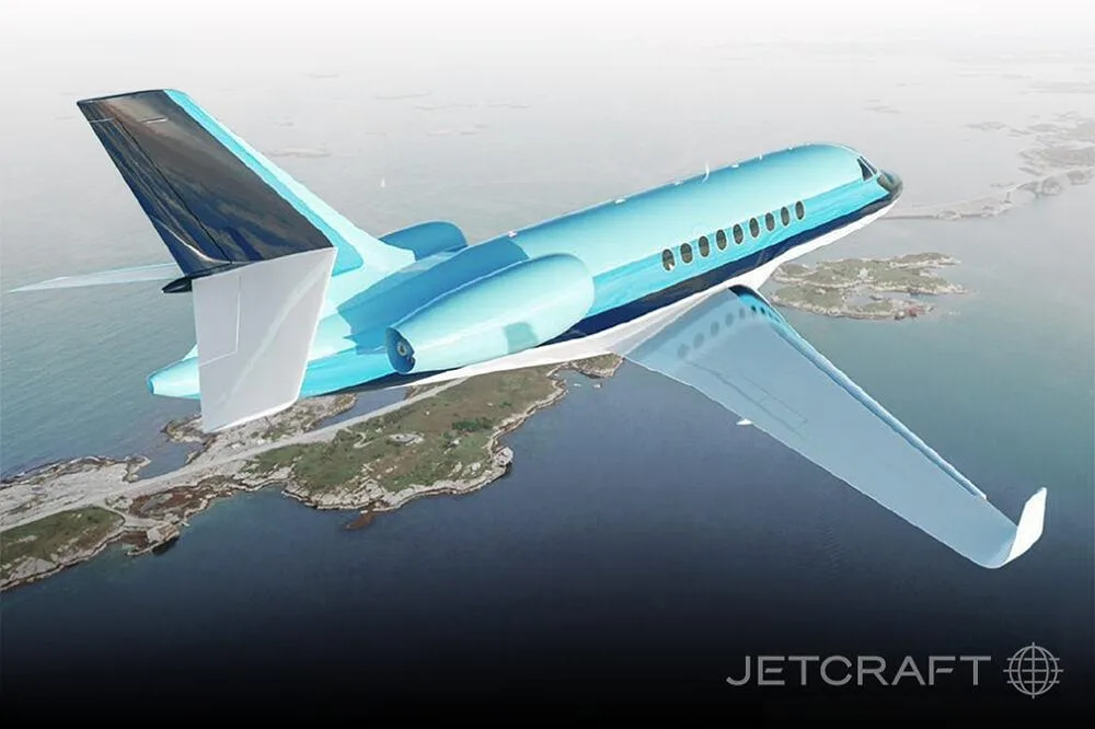 A blue and white business jet flying over a coastline with islands.