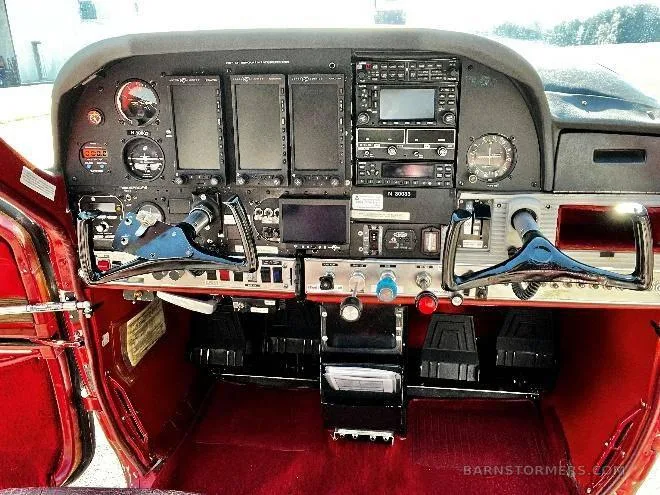 A detailed view of the aircraft's instrument panel with multiple screens and controls.
