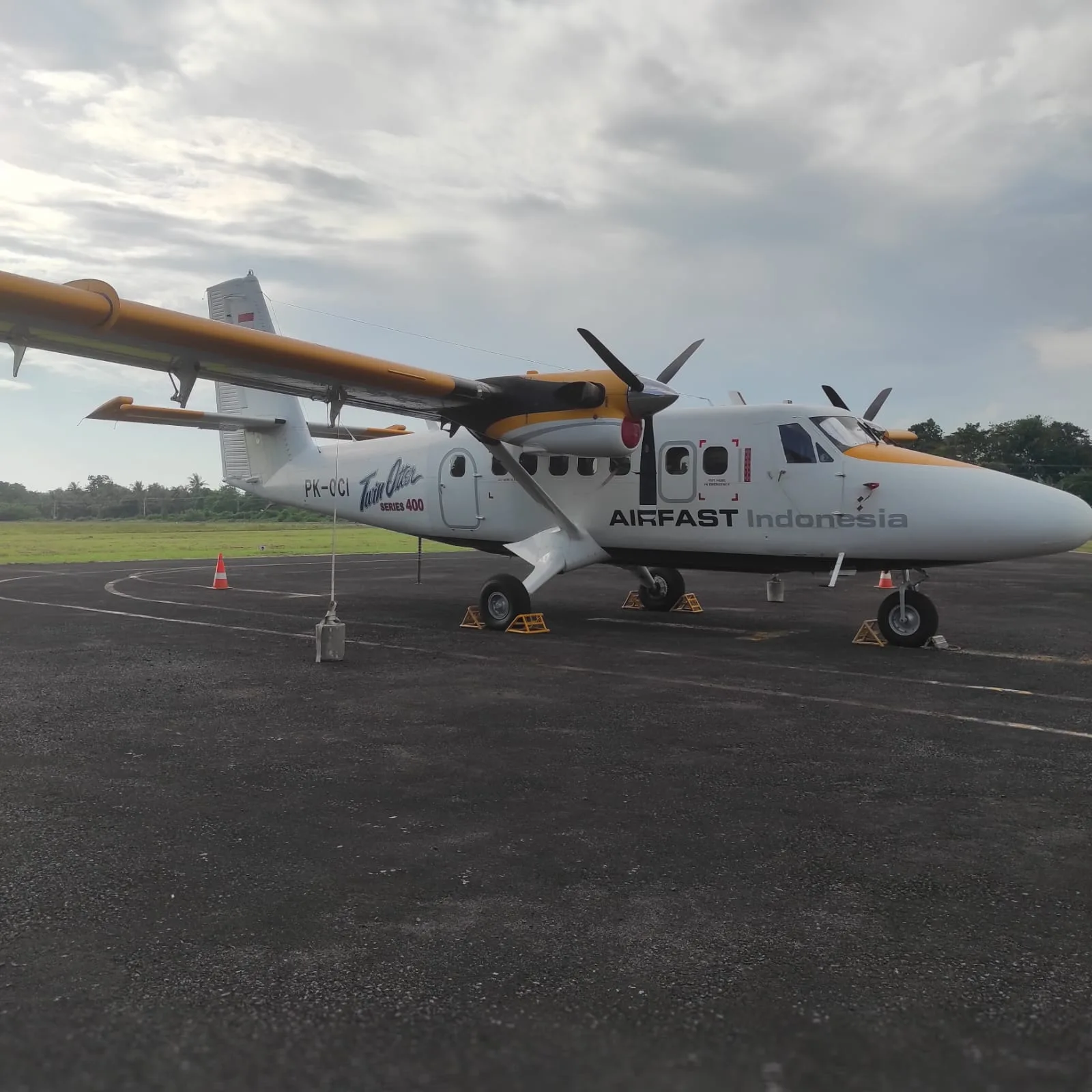 Side view of the PK-OCI Twin Otter Series 400 aircraft on the ground.