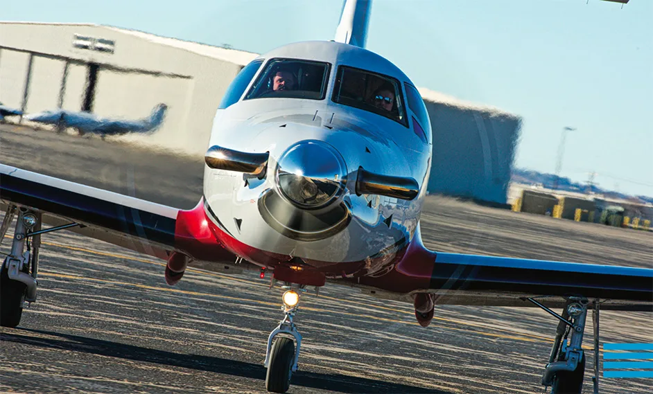 Front view of a Pilatus PC-12 aircraft on the tarmac.