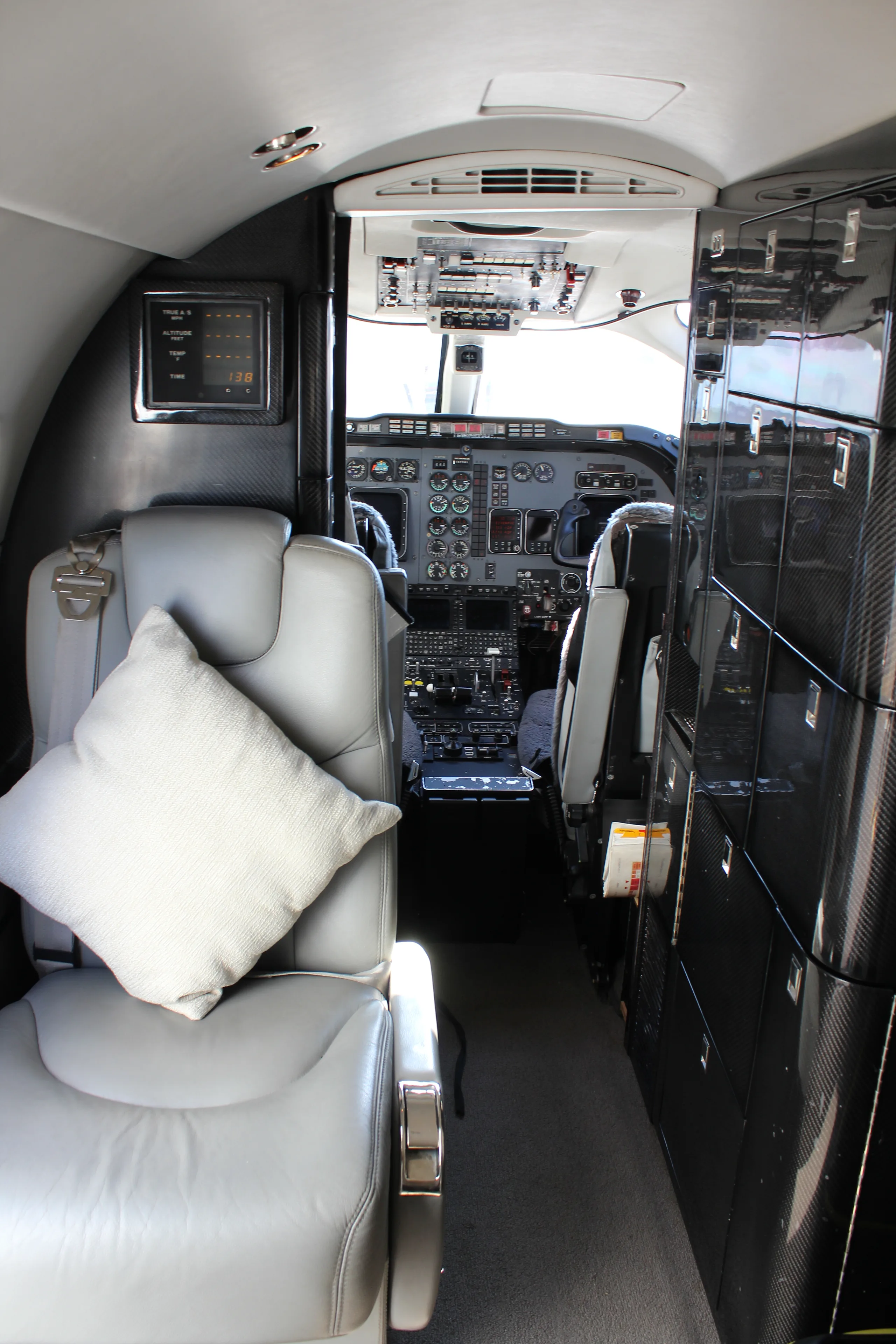 A view of the cockpit instrument panel and seating from the rear of the cabin.
