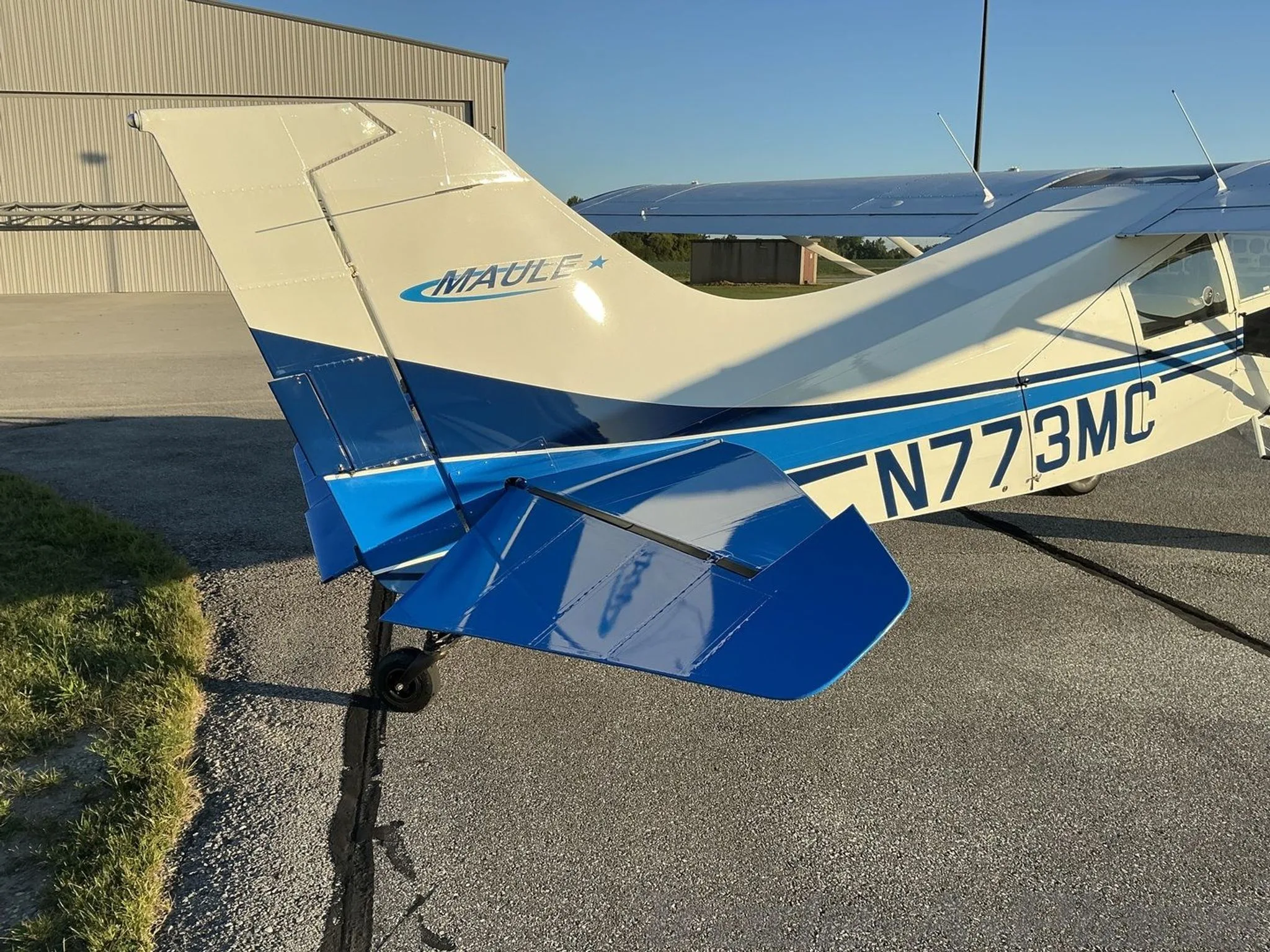 A close-up view of the white and blue tail of a Maule aircraft, showing the N-number N773MC.