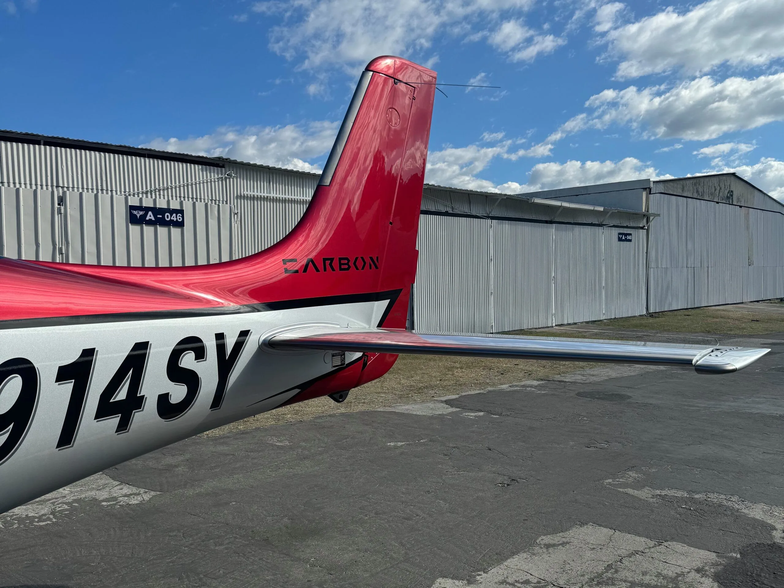 A close-up view of the red tail and horizontal stabilizer of the Cirrus SR22 aircraft N914SY.