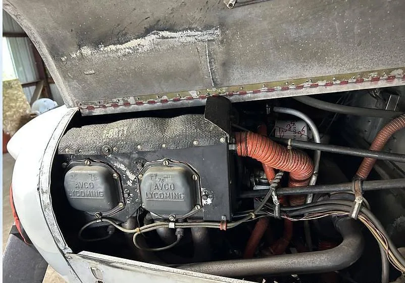 A close-up view of the open engine compartment of the Piper Cherokee 140, showing the Avco Lycoming engine.
