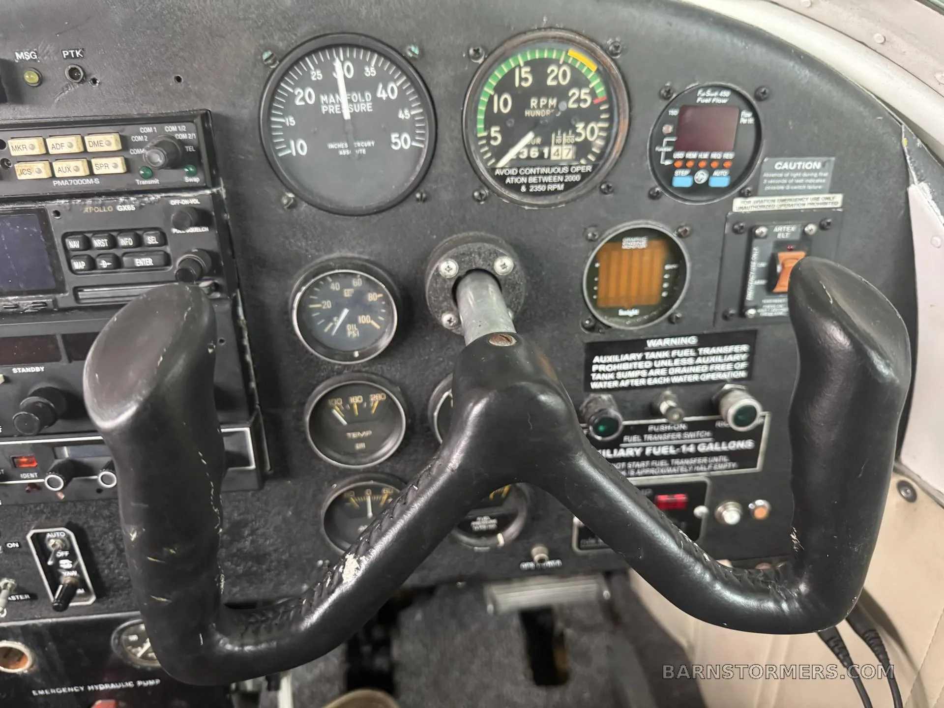 A detailed view of an aircraft's instrument panel, showing various gauges and a control yoke.
