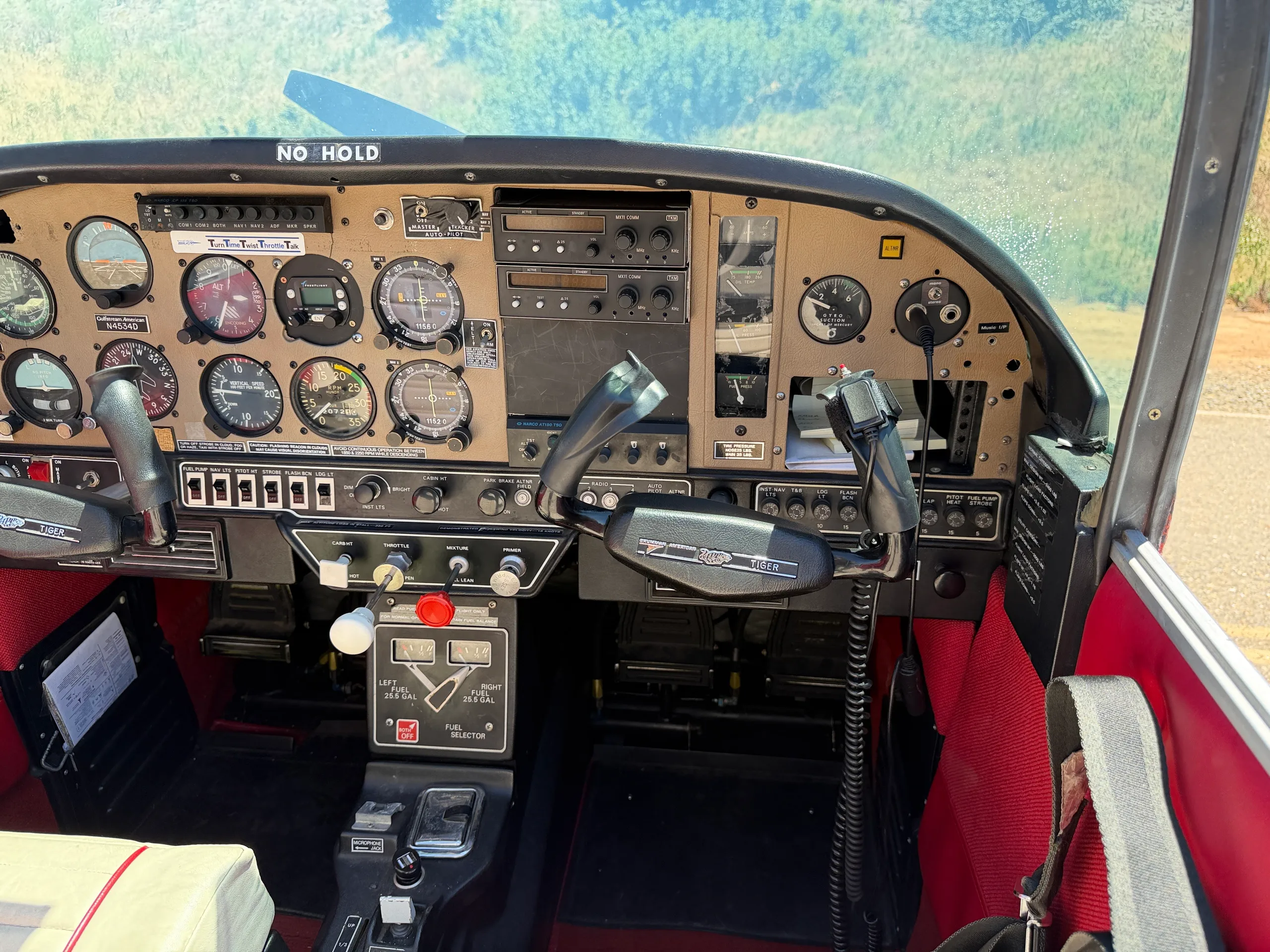 A wide view of the aircraft's cockpit, highlighting the instrument panel and dual yokes.