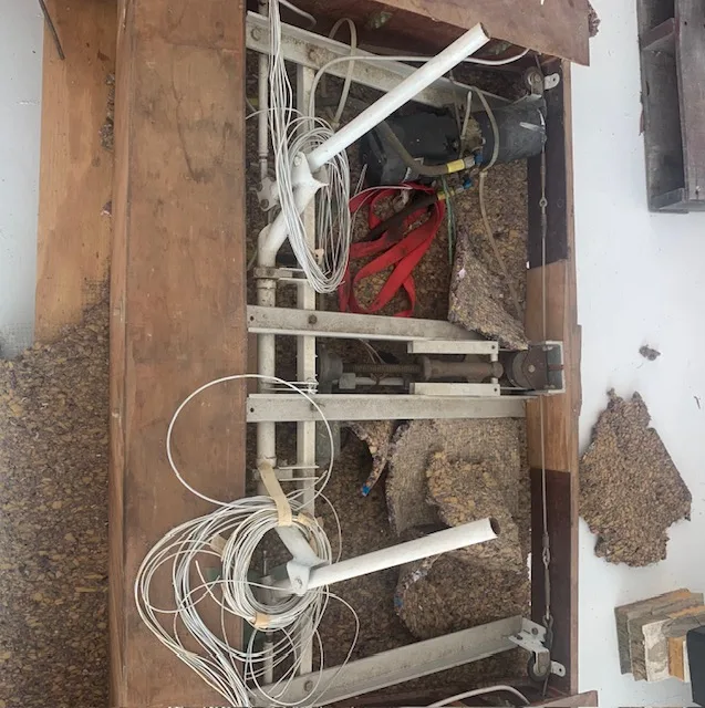 An open section of an aircraft wing or fuselage showing internal wiring, insulation, and structural components.