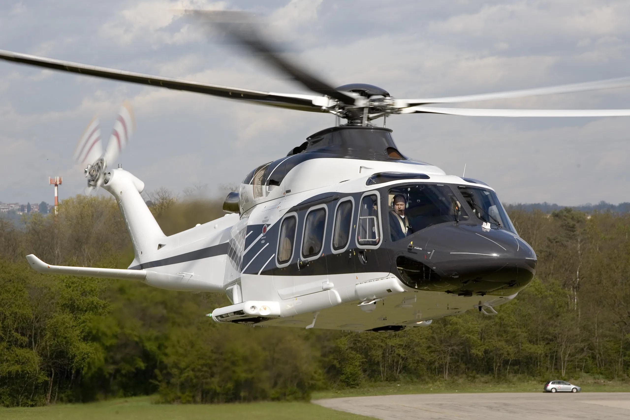 AgustaWestland AW139 helicopter taking off from a runway.