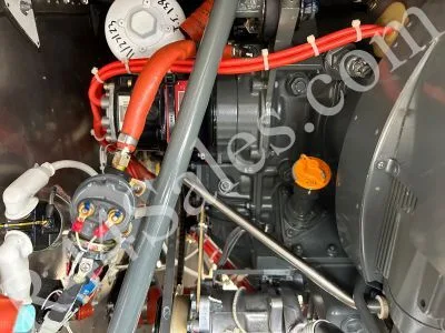 A close-up view of the engine compartment of a helicopter, showing various mechanical components and wiring.