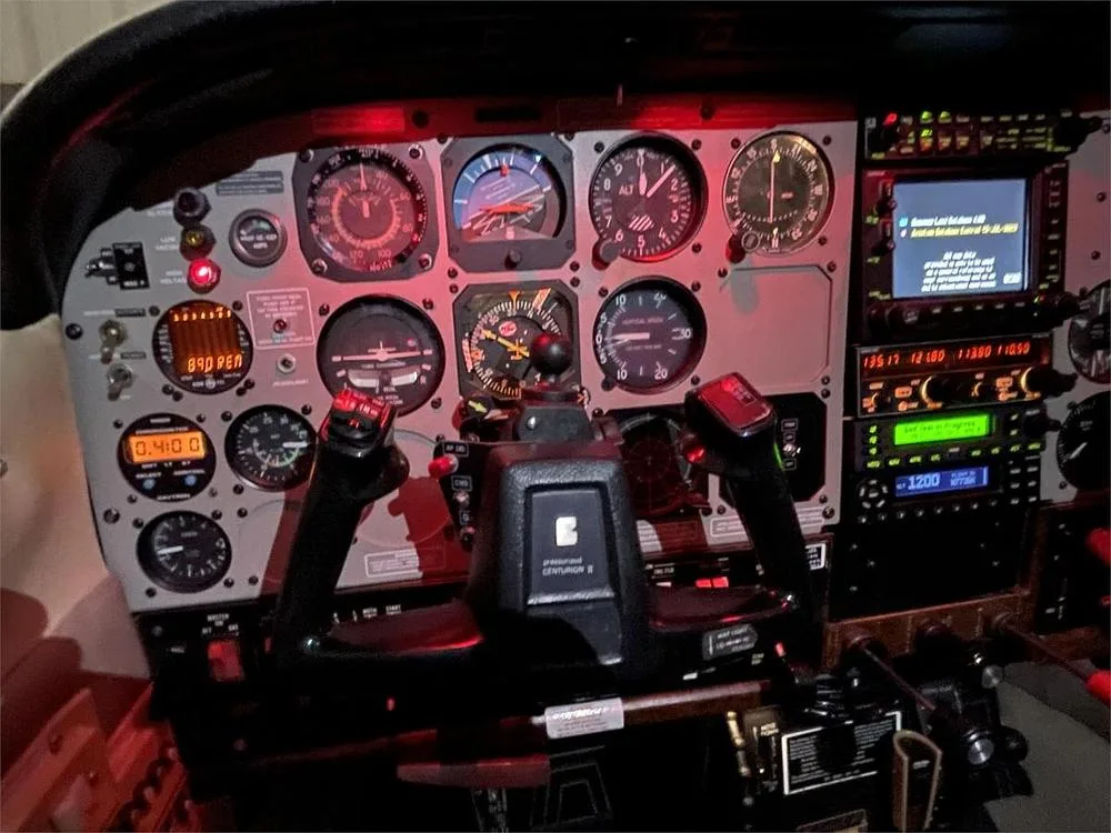 A detailed view of the cockpit instrument panel with a control yoke and various gauges.