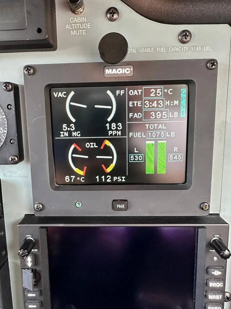 A close-up of a digital cockpit display showing VAC, FF OAT, ETE, FAD, OIL, and TOTAL FUEL readings.