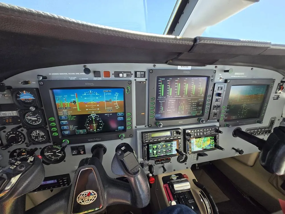 A detailed view of the Piper Meridian cockpit instrument panel, featuring multiple digital displays and controls.