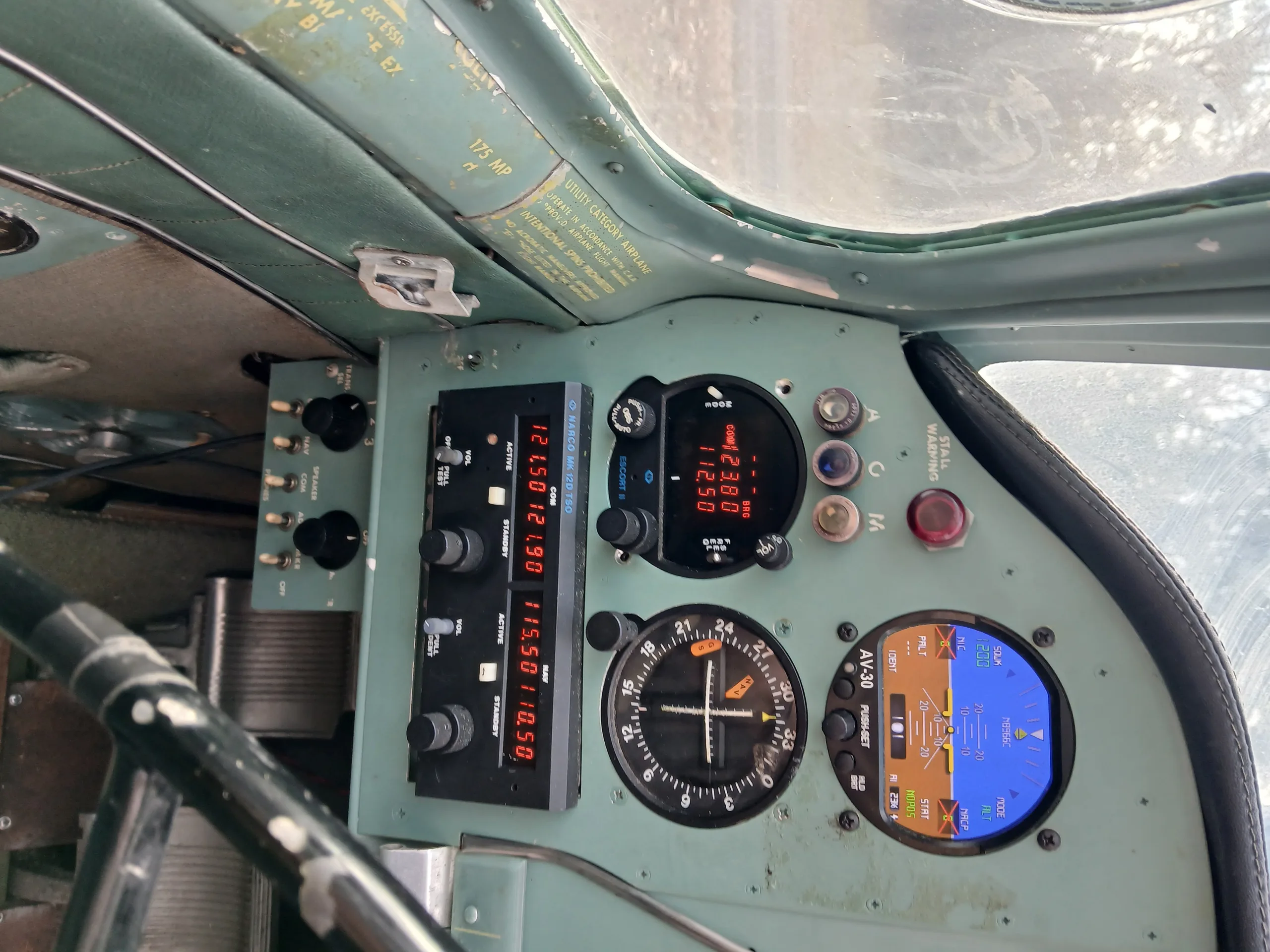 The cockpit instrument panel features both modern digital displays and traditional gauges.