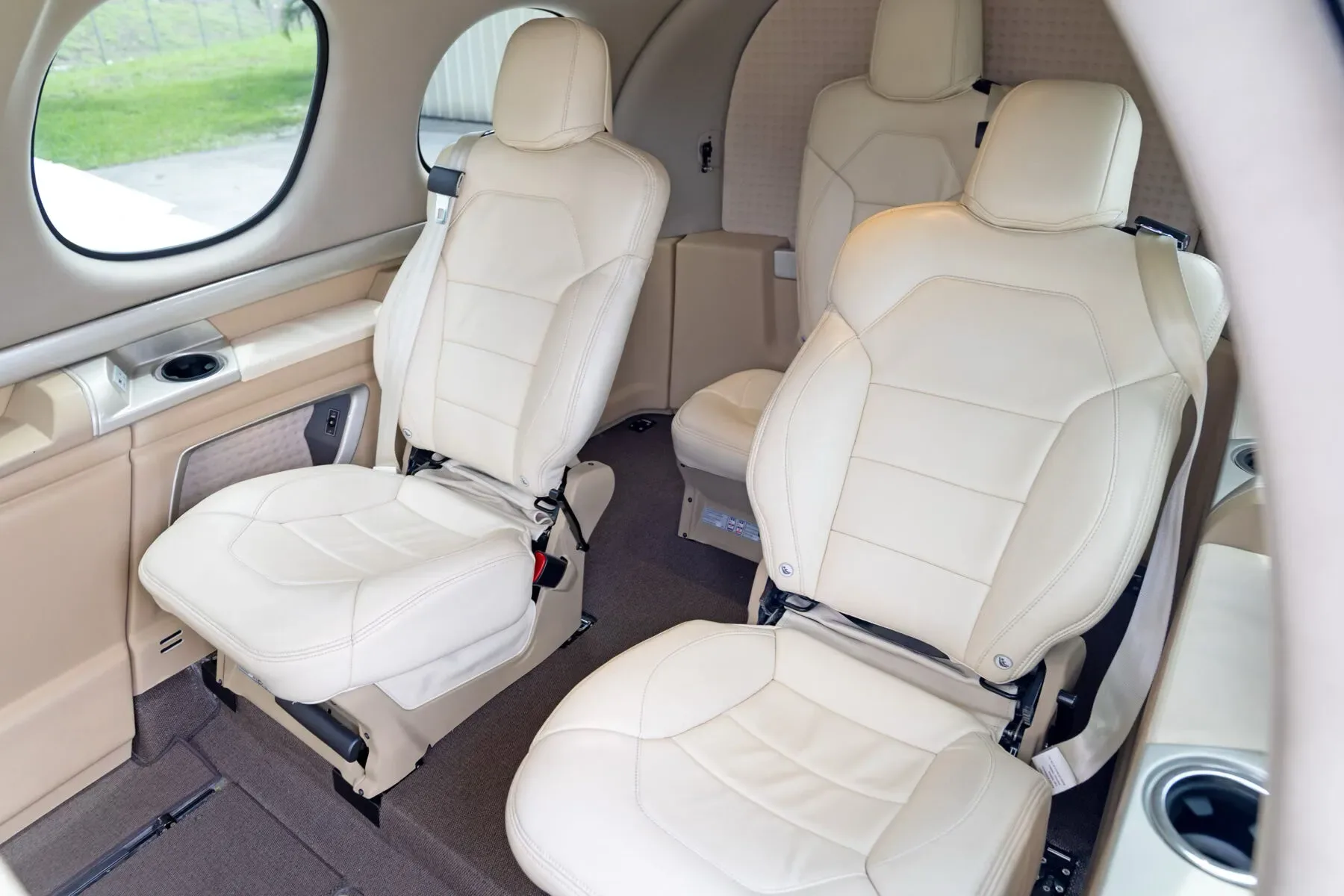 The cream-colored leather passenger seats in the cabin of the Cirrus Vision Jet.
