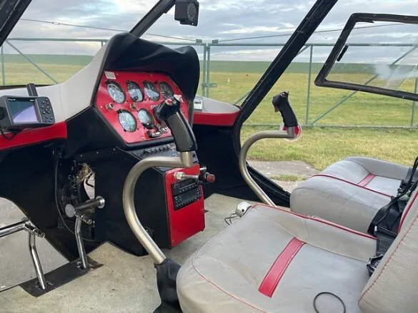The cockpit of the 1978 ENSTROM F-28 showing controls and instruments.