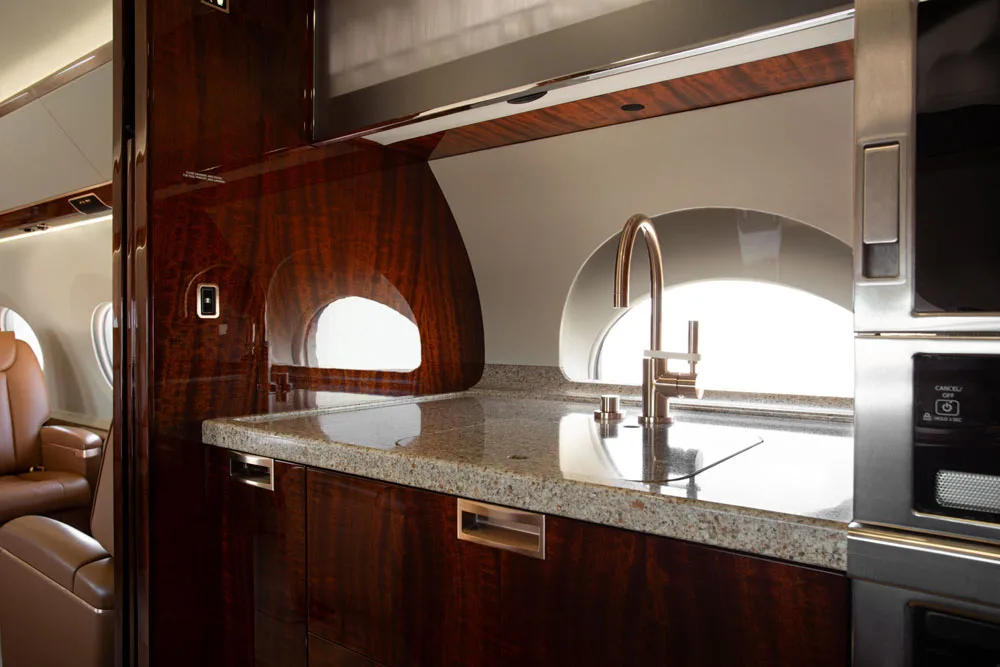 Aircraft galley with sink and microwave.
