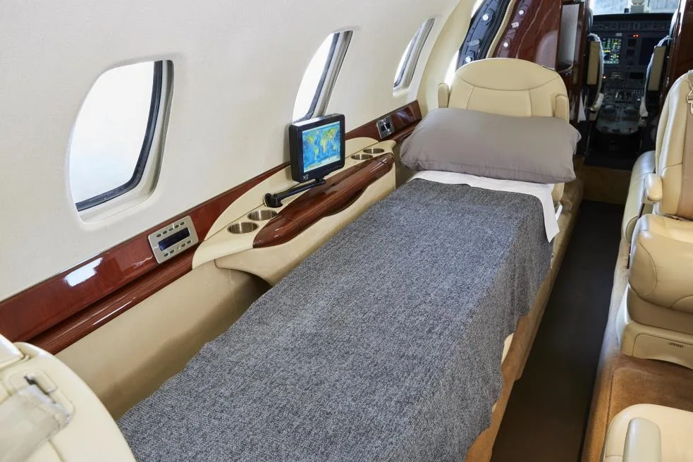 View of the aircraft interior with a divan converted into a bed.
