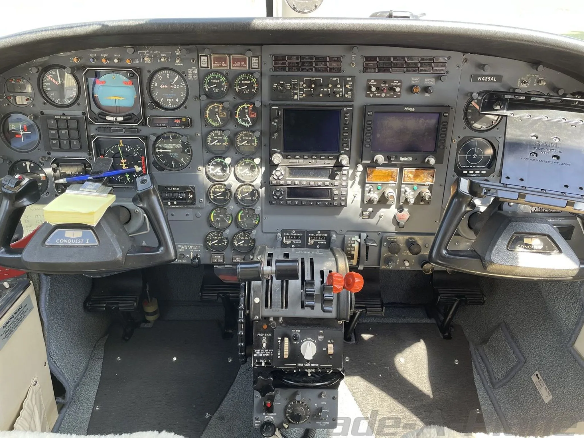 A detailed view of the Cessna 441 Conquest II cockpit instrument panel, showing gauges, screens, and controls.