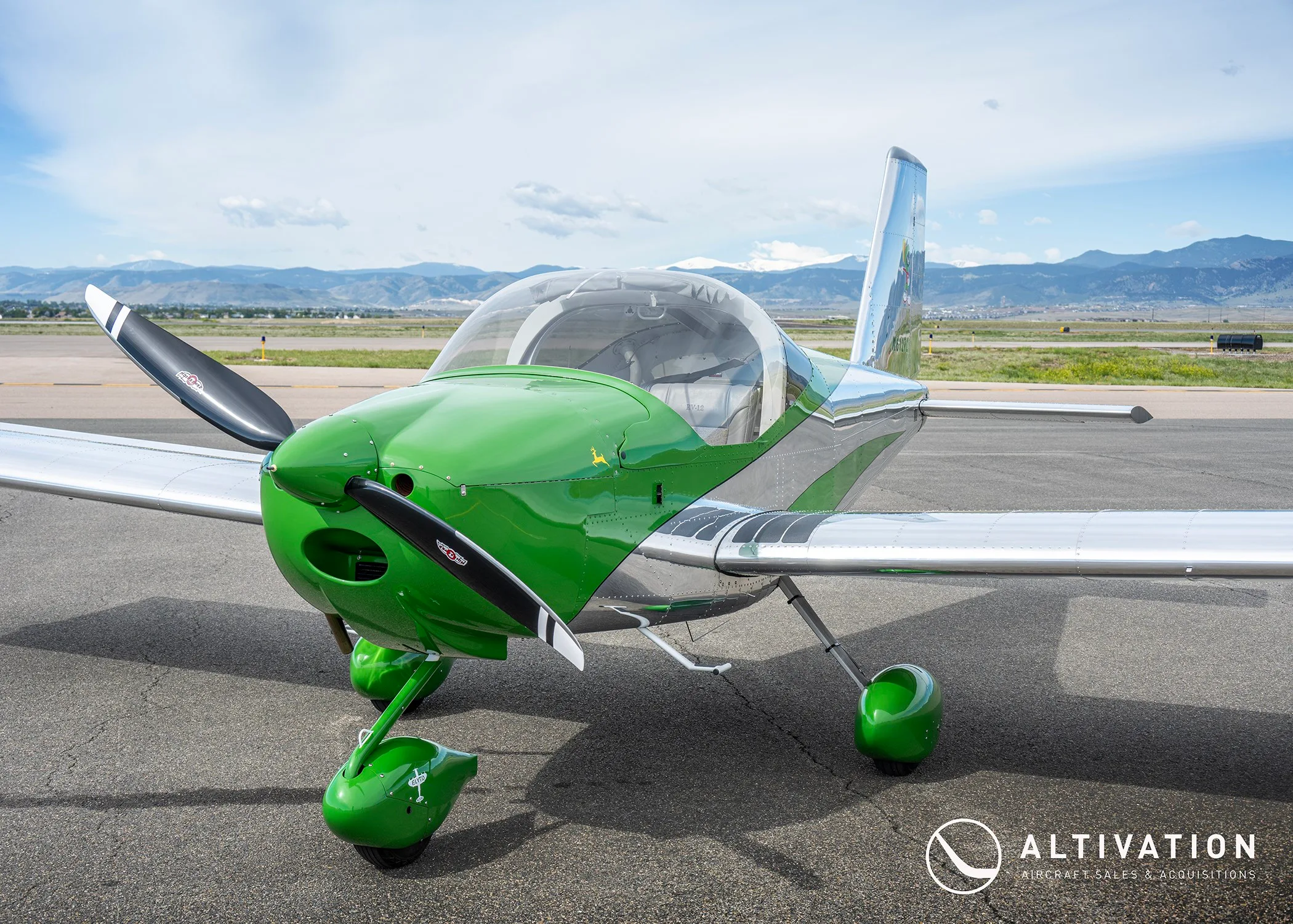 A front-quarter view of a green and polished aluminum Vans RV-12 aircraft, registration N612PC, showing the propeller and landing gear.