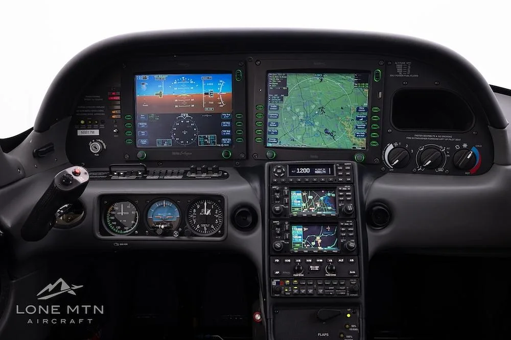 The cockpit of a Cirrus SR22T aircraft, featuring a modern glass panel display with multiple screens.